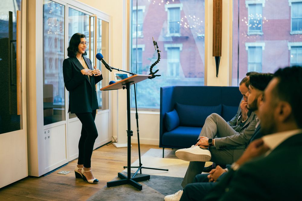 People gathered in a bright modern office space during a casual meeting.