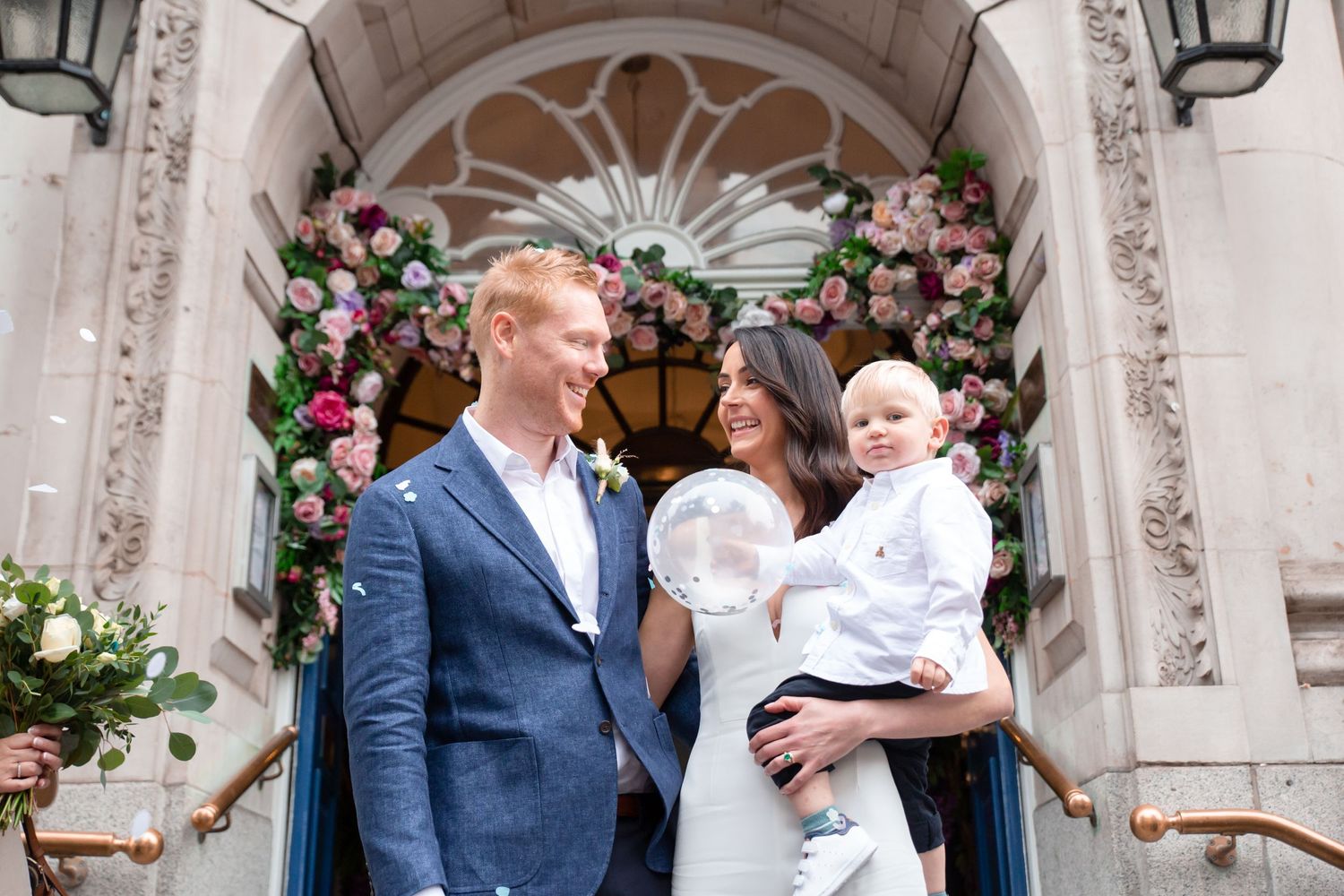 bride and groom in chelsea registry office london with son