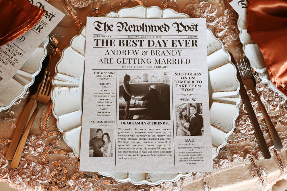 Custom wedding newspaper with 'The Best Day Ever' headline laid on reflective surface.