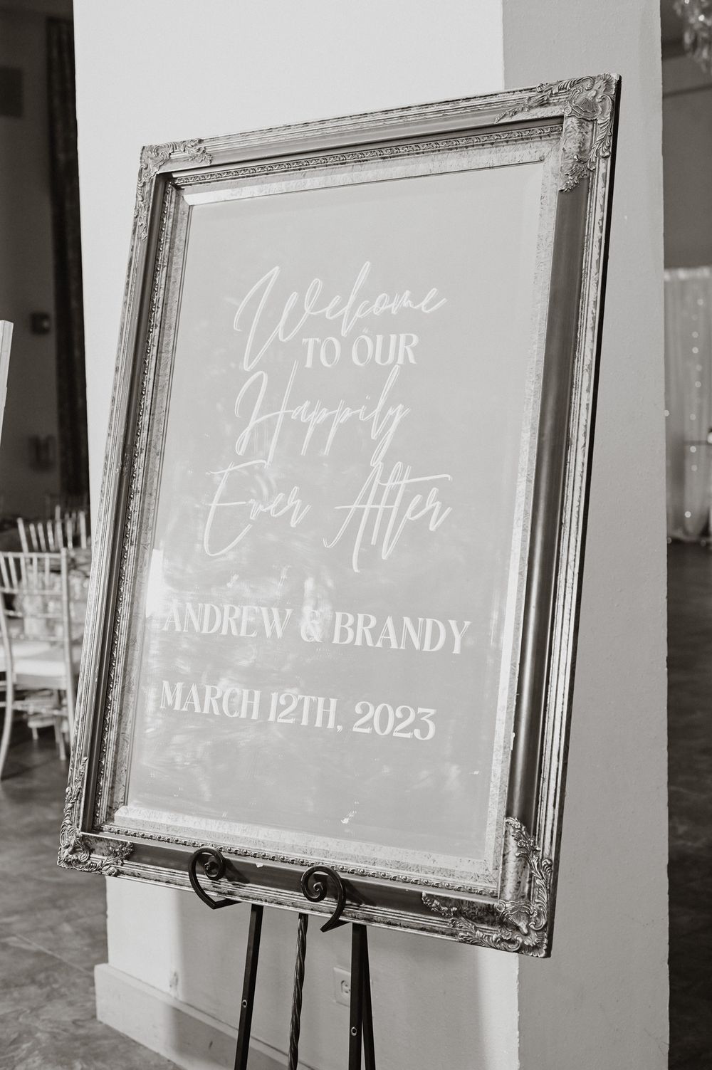 Vintage framed welcome sign for March 2025 wedding displaying couple's names in elegant script.