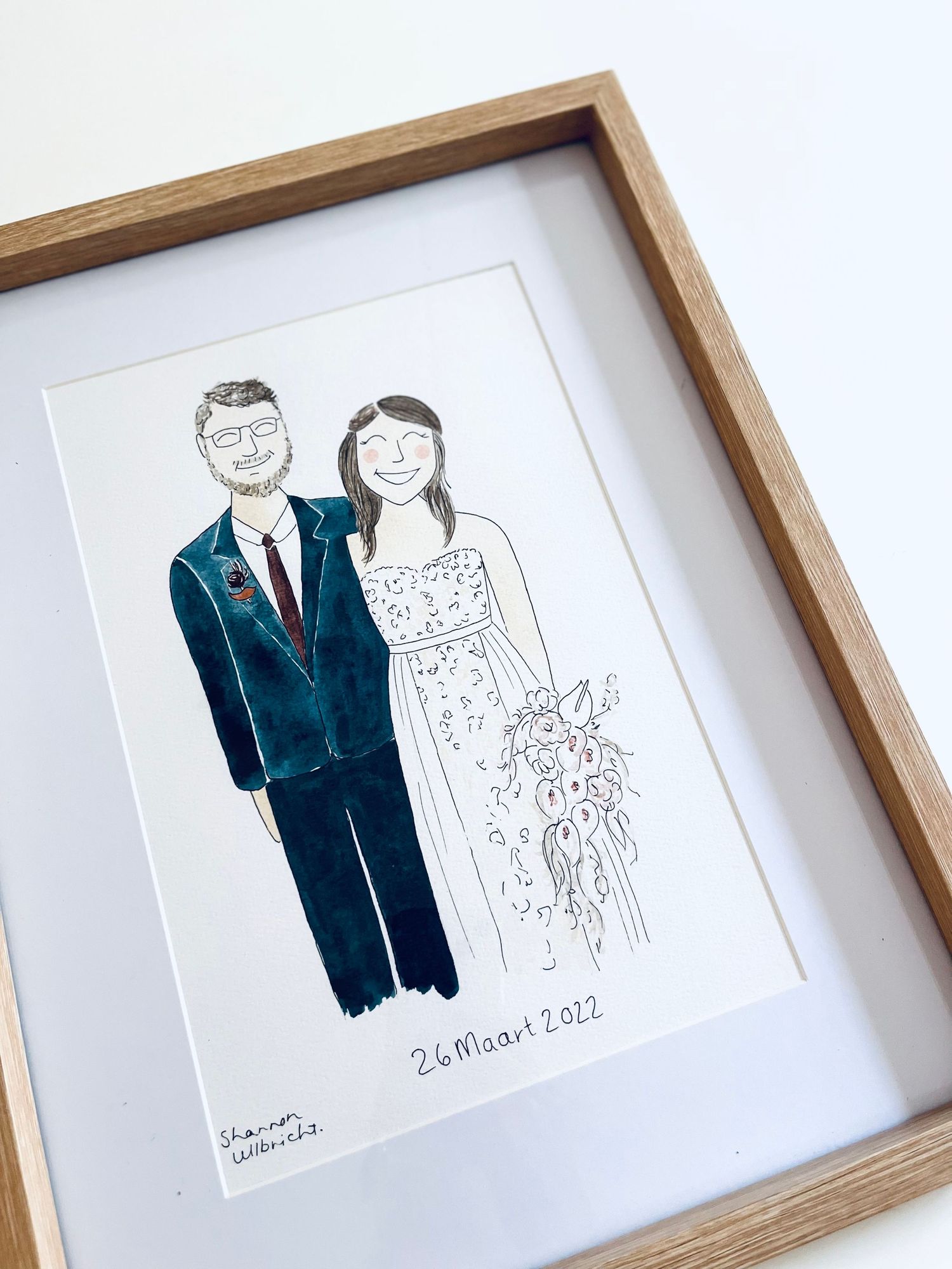 Hand painted illustration of a married couple in a light wooden frame.