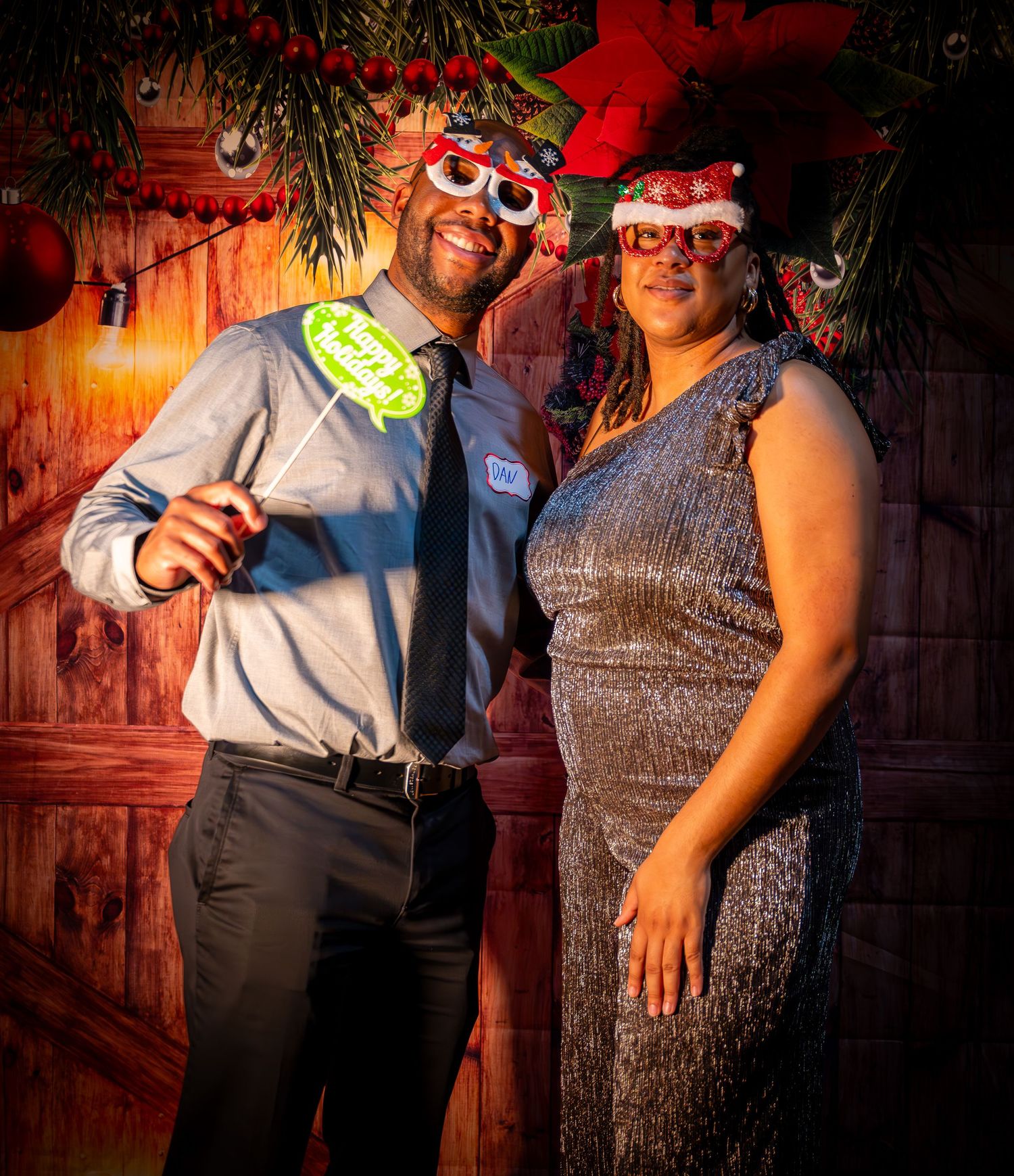 Party guests in formal attire standing together against a rustic backdrop with dramatic lighting.