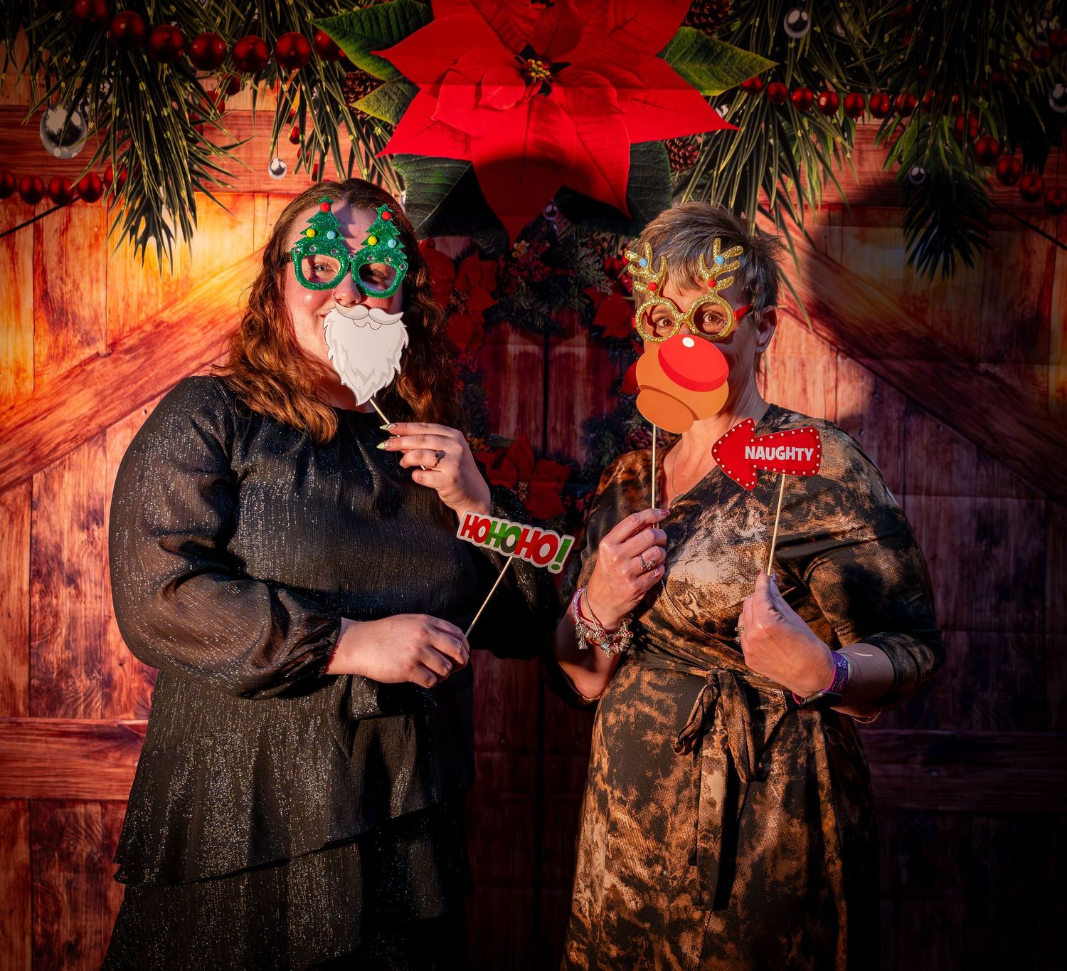 Holiday party scene with attendees in formal attire under dramatic lighting and seasonal decorations.