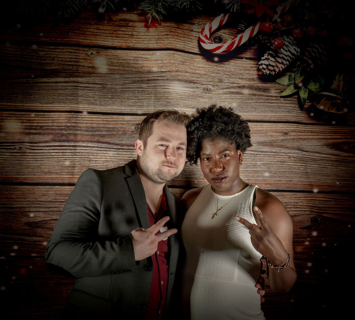 Joyful party moments captured against rustic wooden wall with festive lighting.