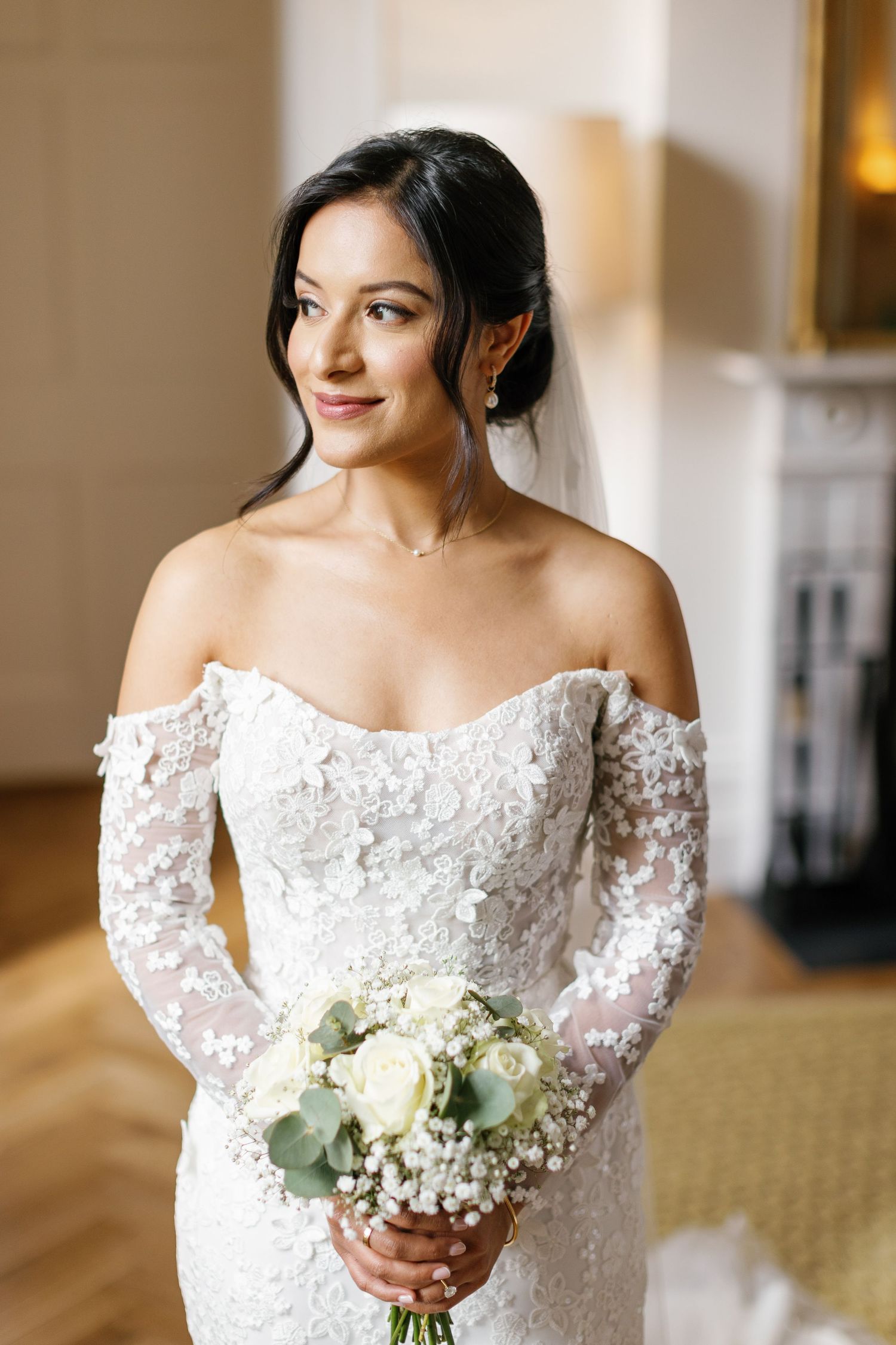 Bride holding her white bouquet at the Grove Hotel in Watford