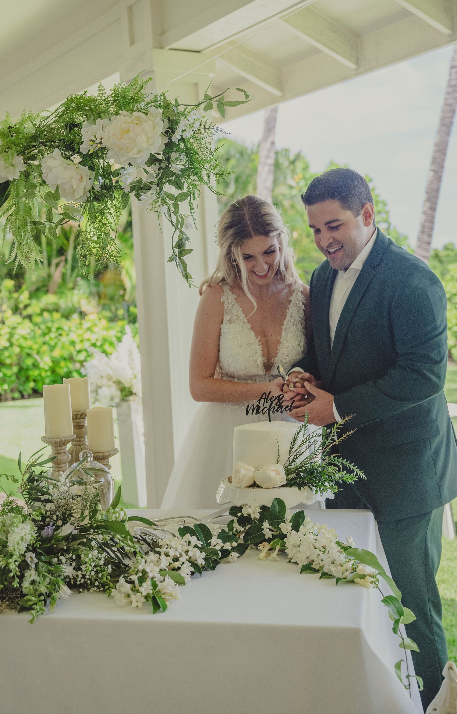 Wedding ceremony setup with floral arch decorations and white roses adorning an indoor venue.