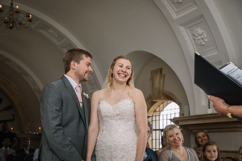 A joyful moment captured during a wedding ceremony in an elegant venue.