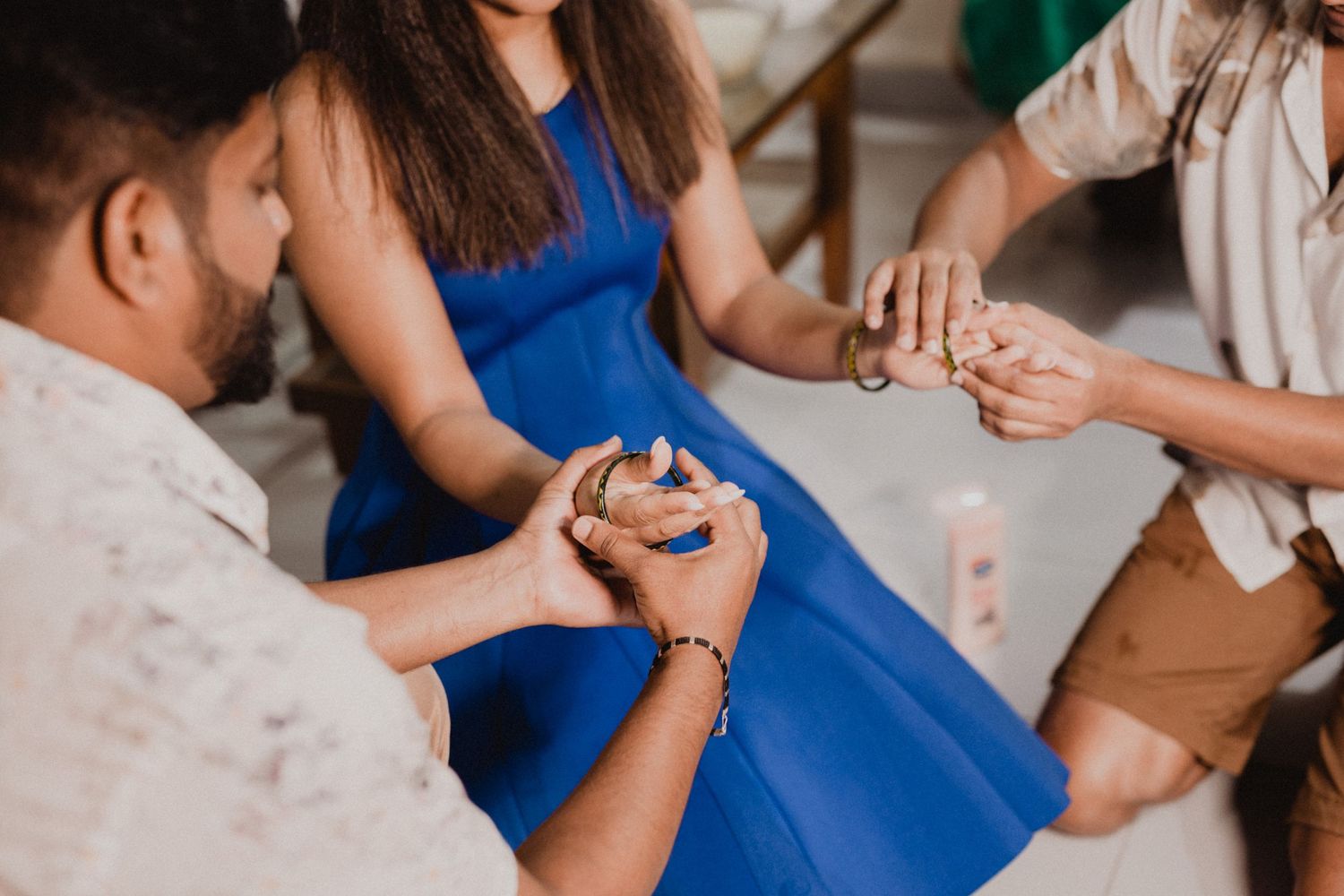 People in colorful attire sharing joyful moments at an indoor party.