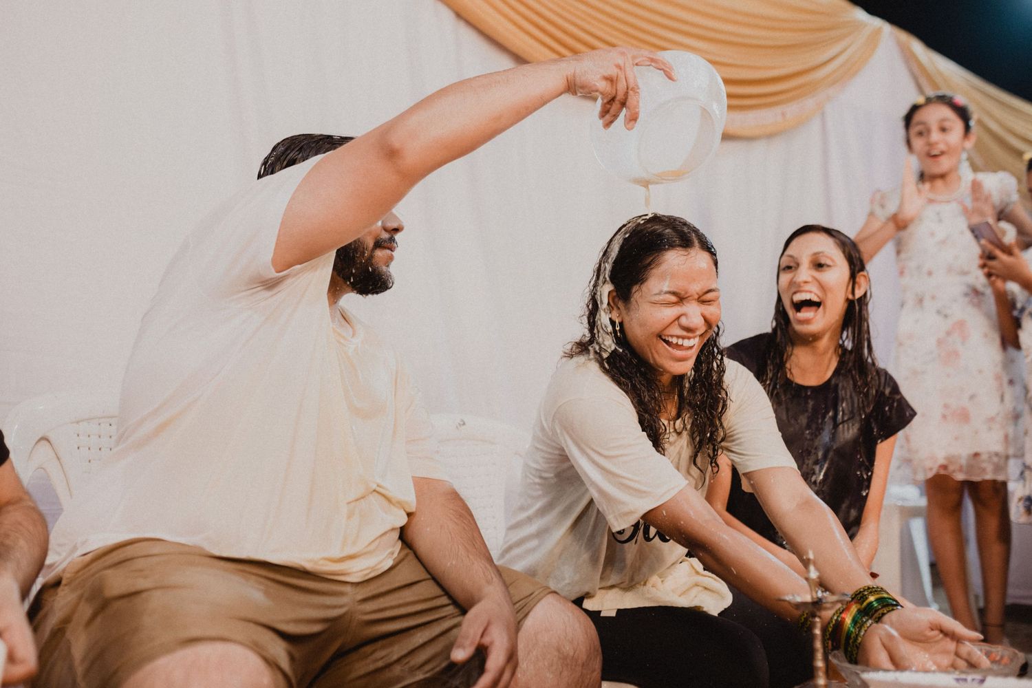 Lively indoor celebration with people enjoying animated conversations.