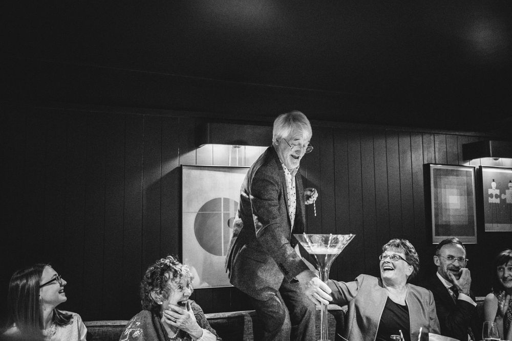 A candid black and white photo capturing lively entertainment at an indoor venue.