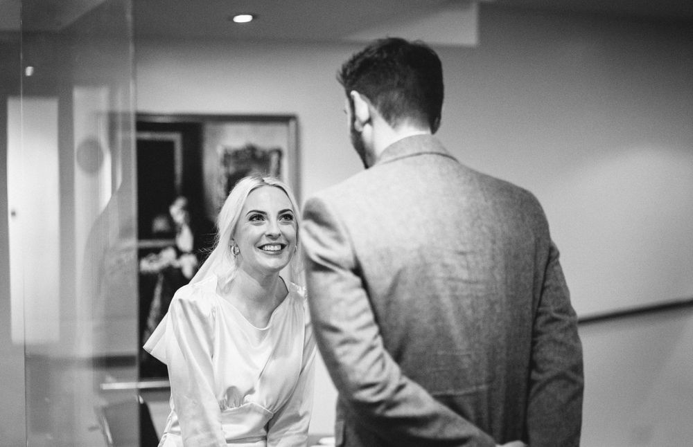 A couple having an intimate conversation in black and white before their ceremony.