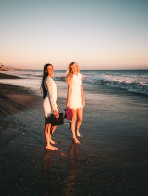 Friends college grad session standing on the beach in Dana Point