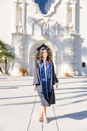 College senior portrait with cap and gown at the University of San Diego