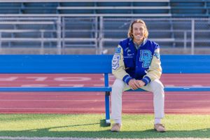 High school senior boy with track letterman's jacket at Dana Hills High School