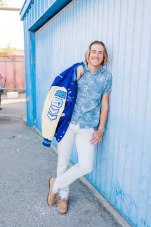 High school senior boy with track letterman's  jacket at Dana Hills High School