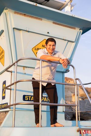 High school senior boy on lifeguard tower in San Clemente