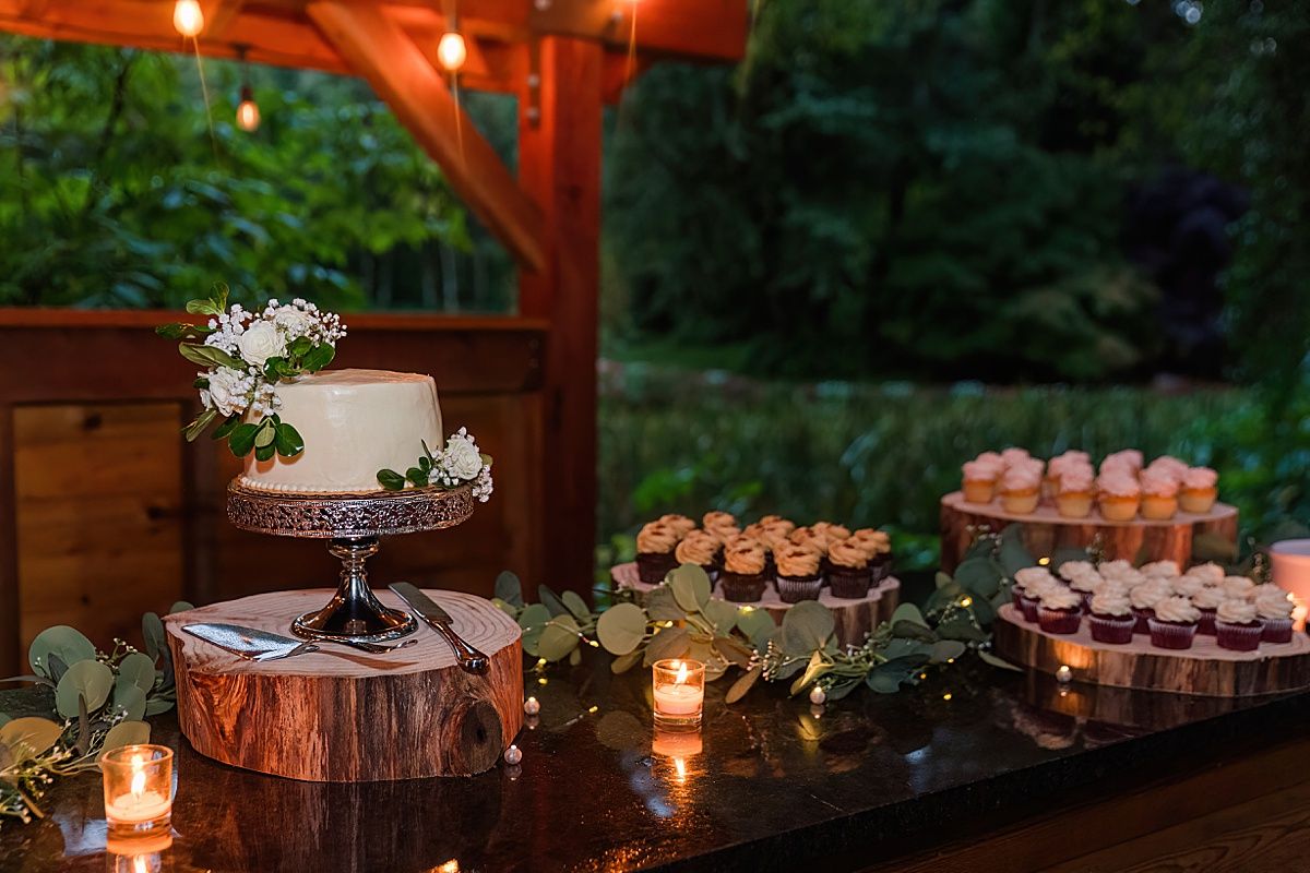 Wedding cake and cupcakes photographed at reception