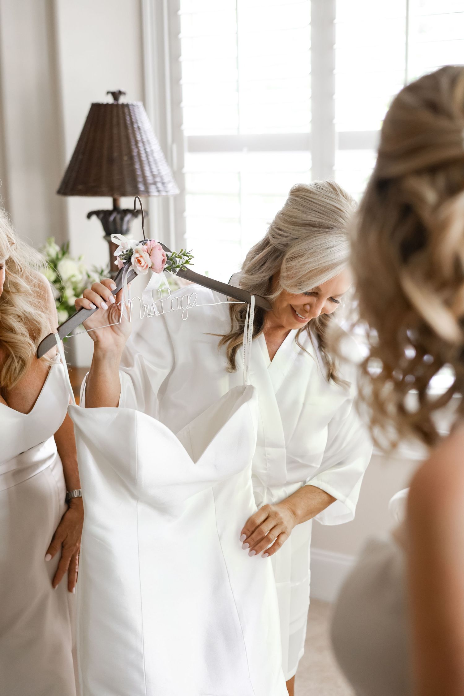 Wedding morning preparations with white robes and soft natural lighting.