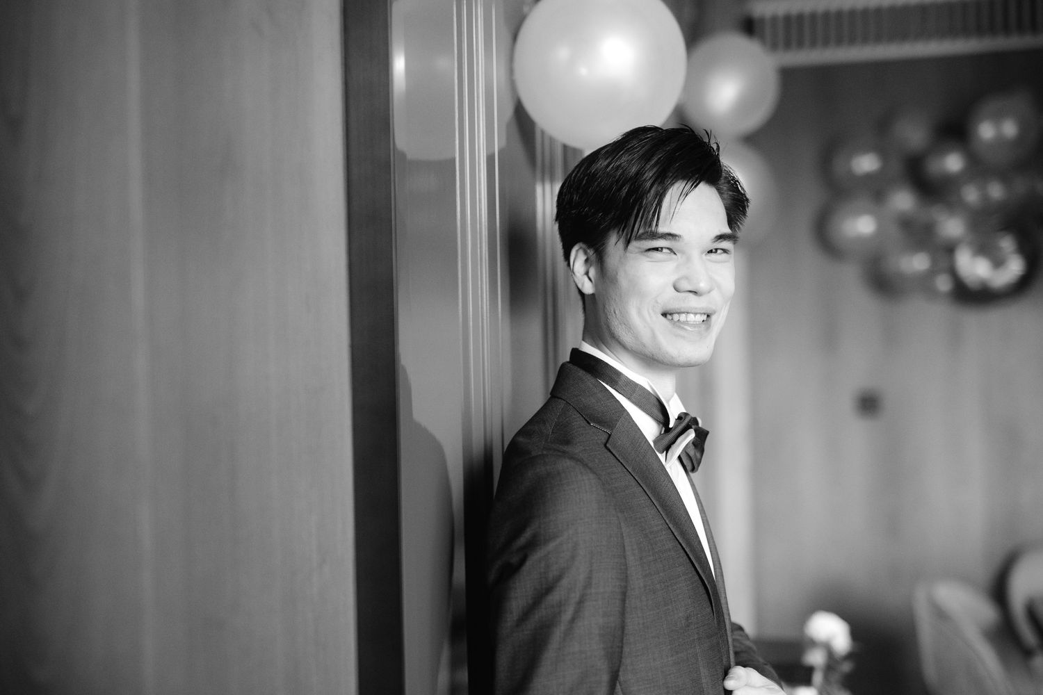 Multiple candid black and white shots showing moments of laughter and joy at a formal event.