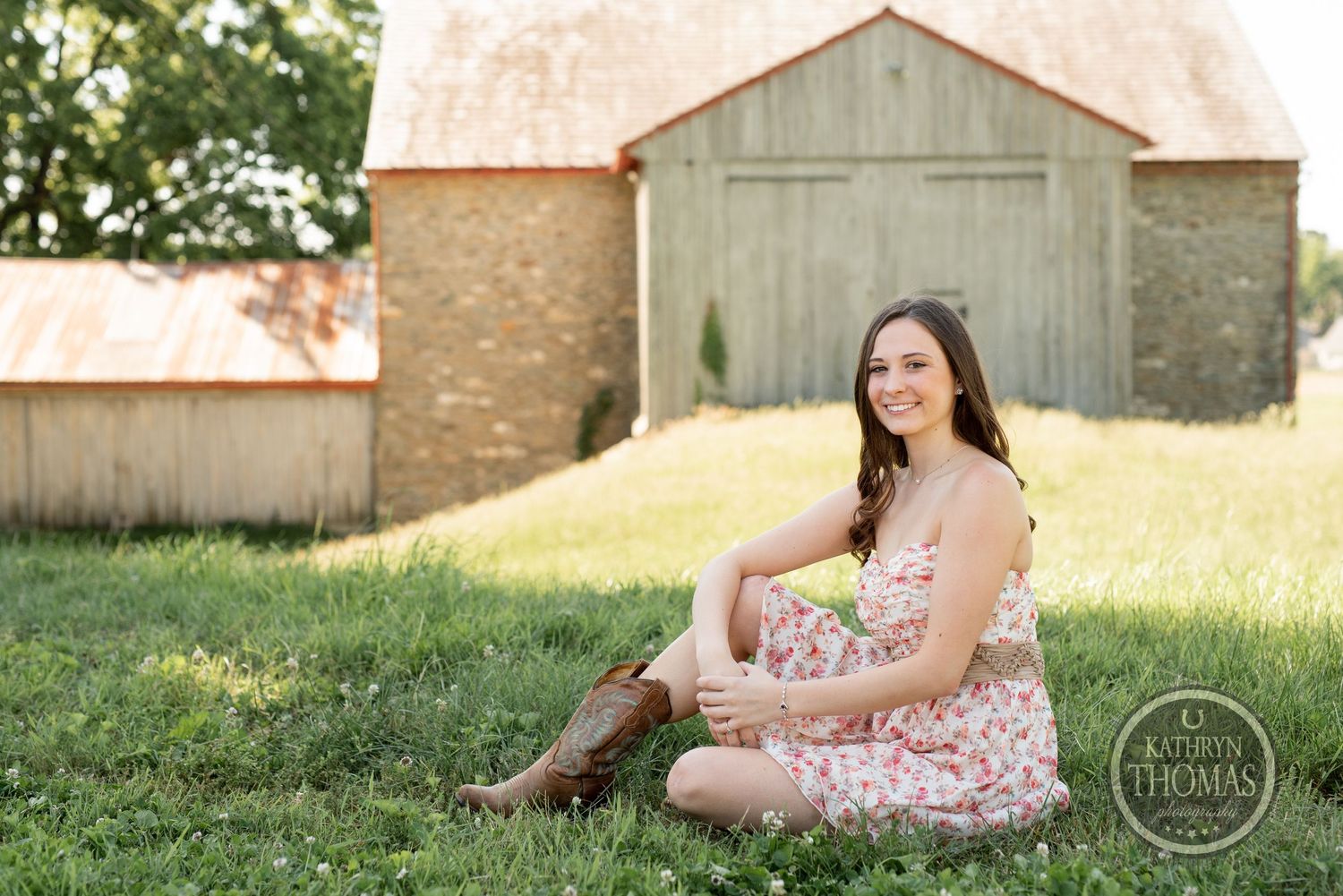 Outdoor photo session with rustic barn and strapless floral dress.