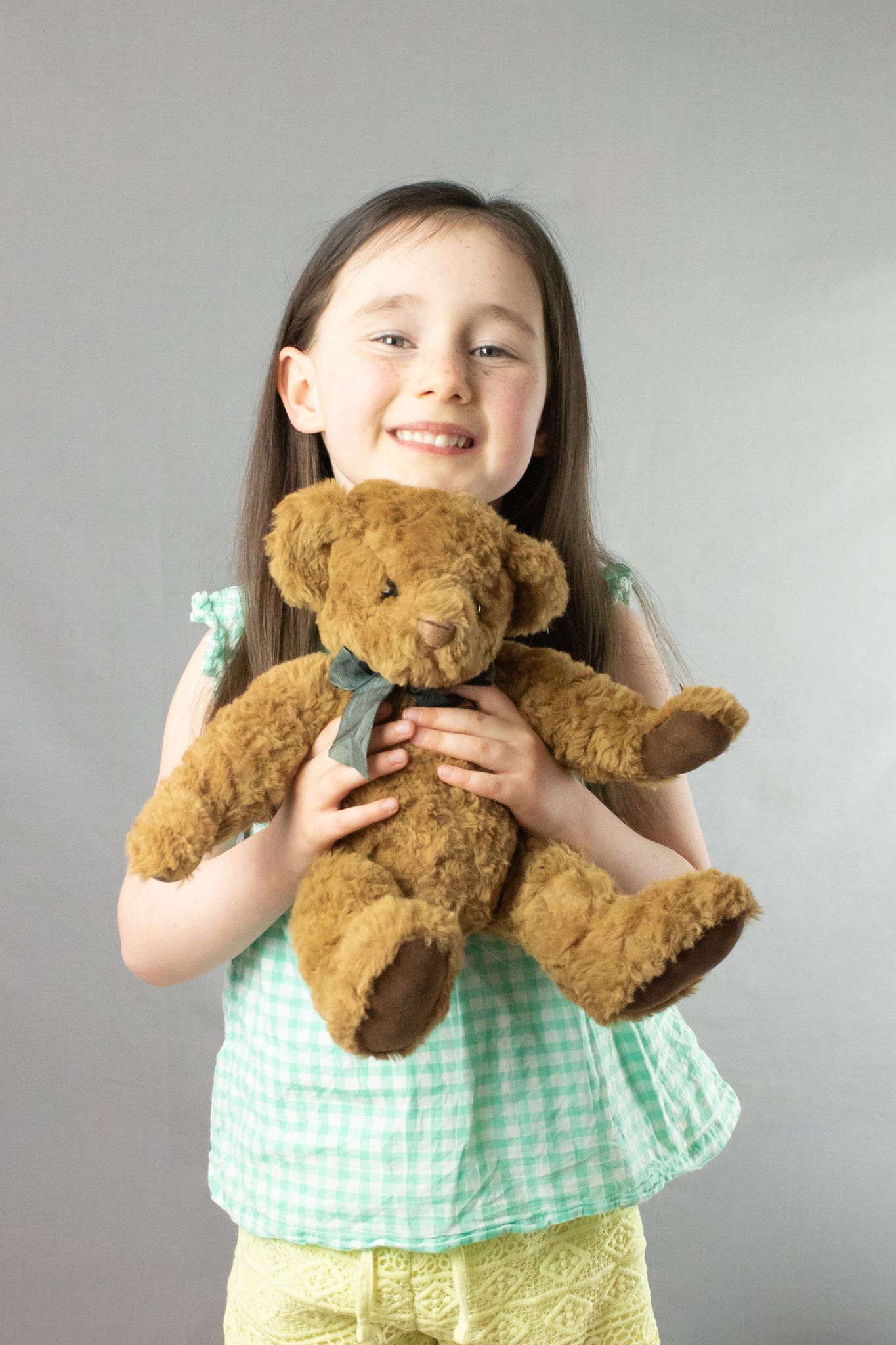 child photography session of girl holding a bare under the arms