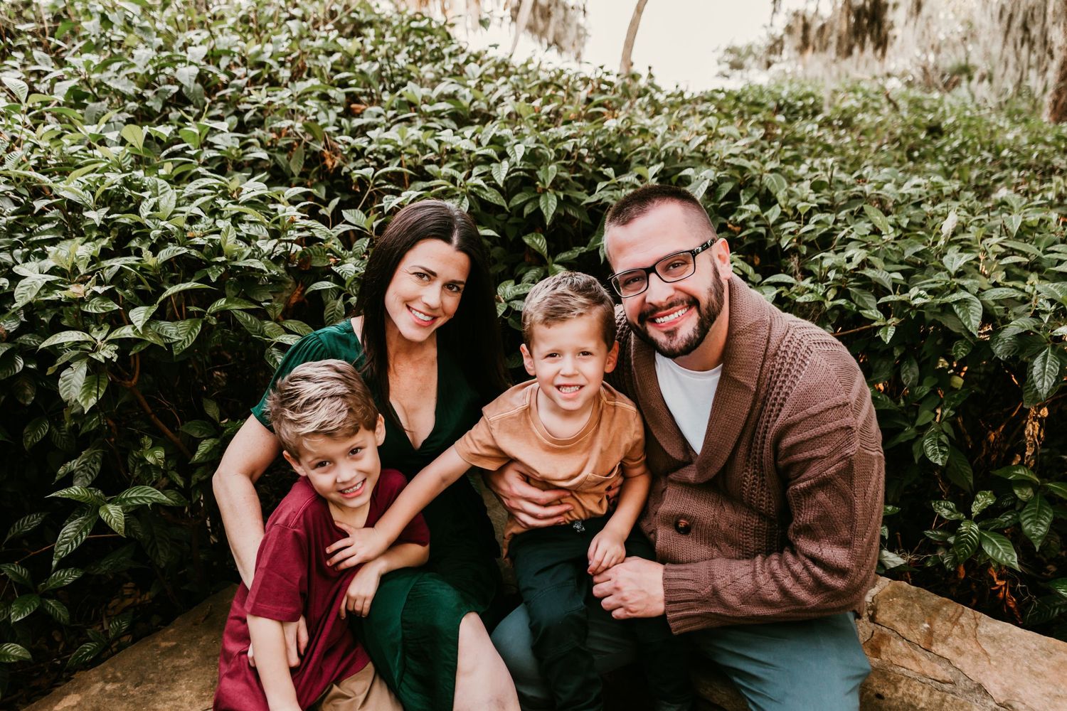Outdoor Family Session Philippe Park in Safety Harbor, FL; family posing on stone wall