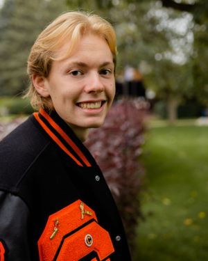 Close-up shots highlighting details of black and orange varsity jacket outdoors.