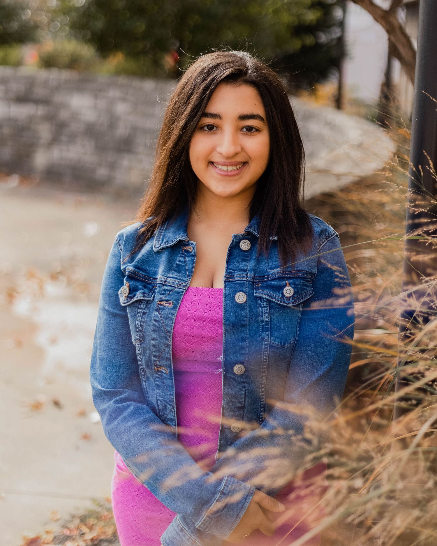 A series of outdoor portrait shots showing someone in a denim jacket and pink top against a natural backdrop.