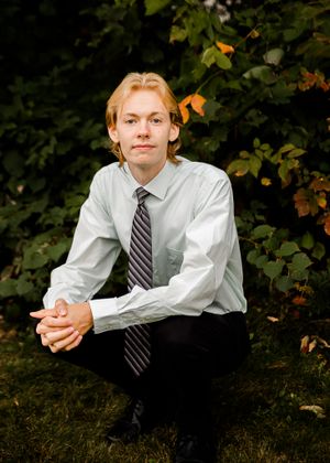 A series of casual portraits showing someone in business attire sitting on grass.