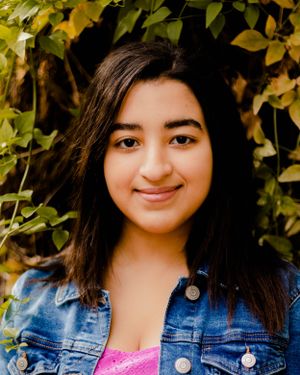 Natural outdoor photography session with golden leaves in the background.