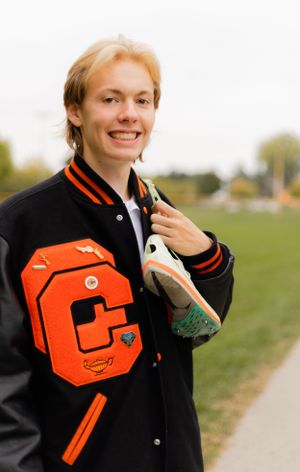 Black and orange varsity jacket detail shots against white background.