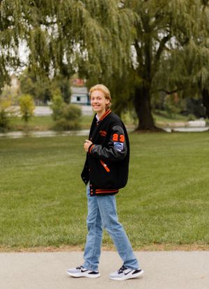 Playful outdoor poses in casual attire with willow trees in background.
