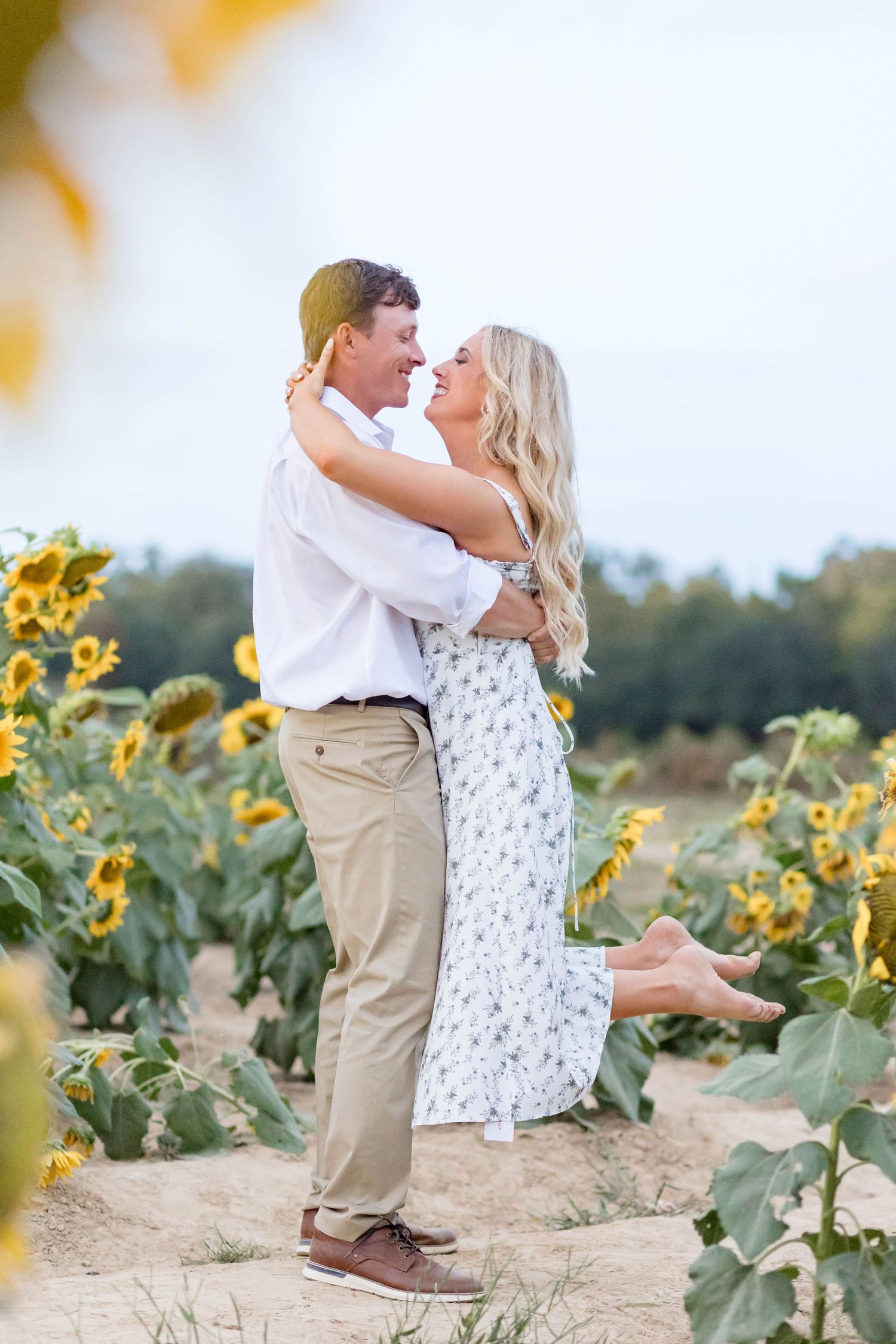 man and woman dance in a sunflower field