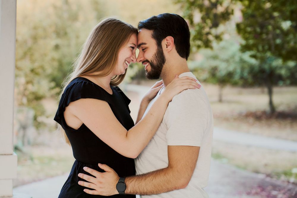 Intimate portrait of couple in casual attire sharing a tender moment.