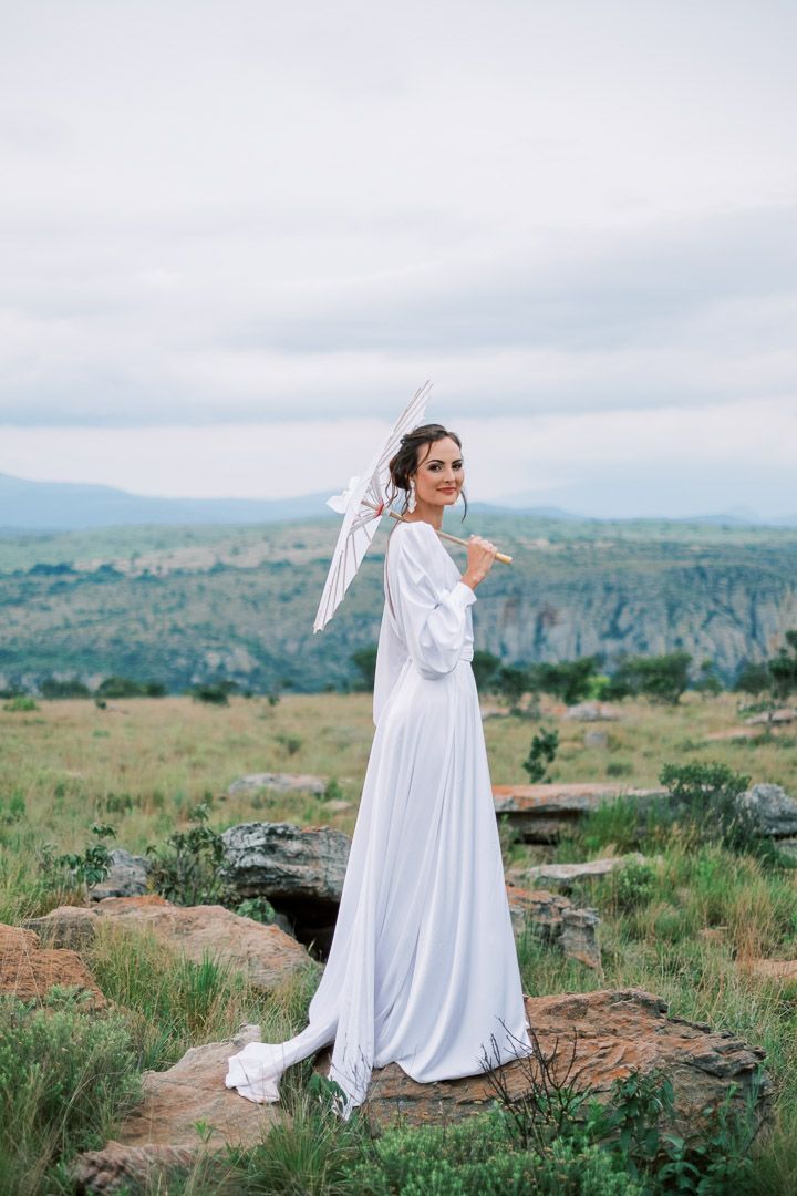 Bride poses outside at God's Window, Mpumalanga