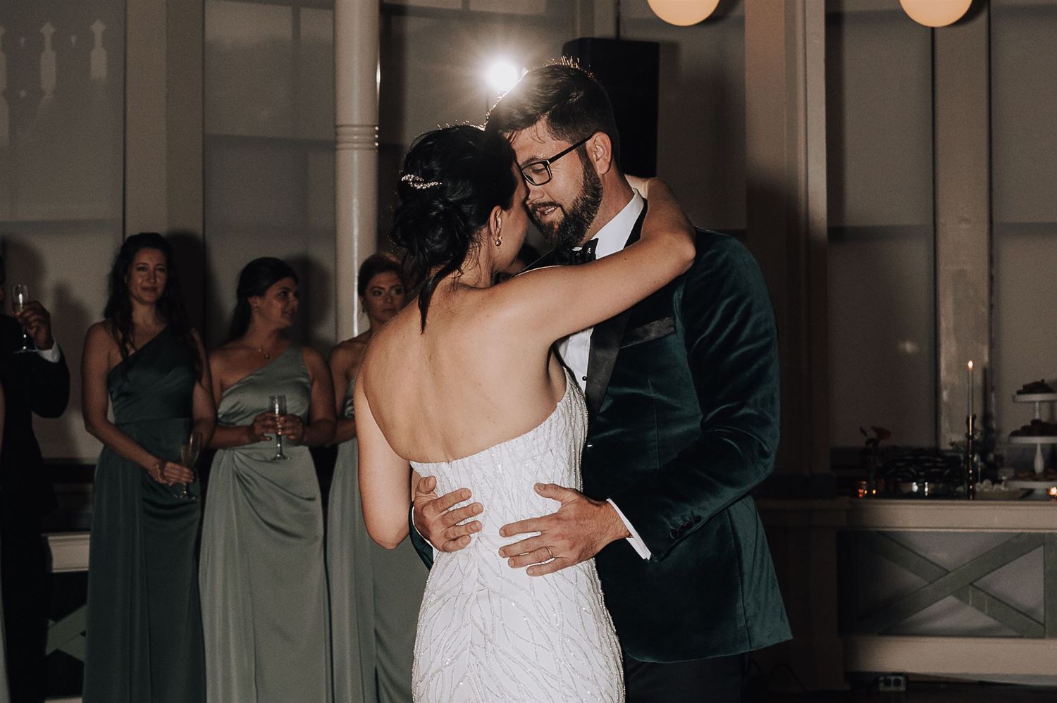 Couple sharing an intimate slow dance moment at their wedding reception.