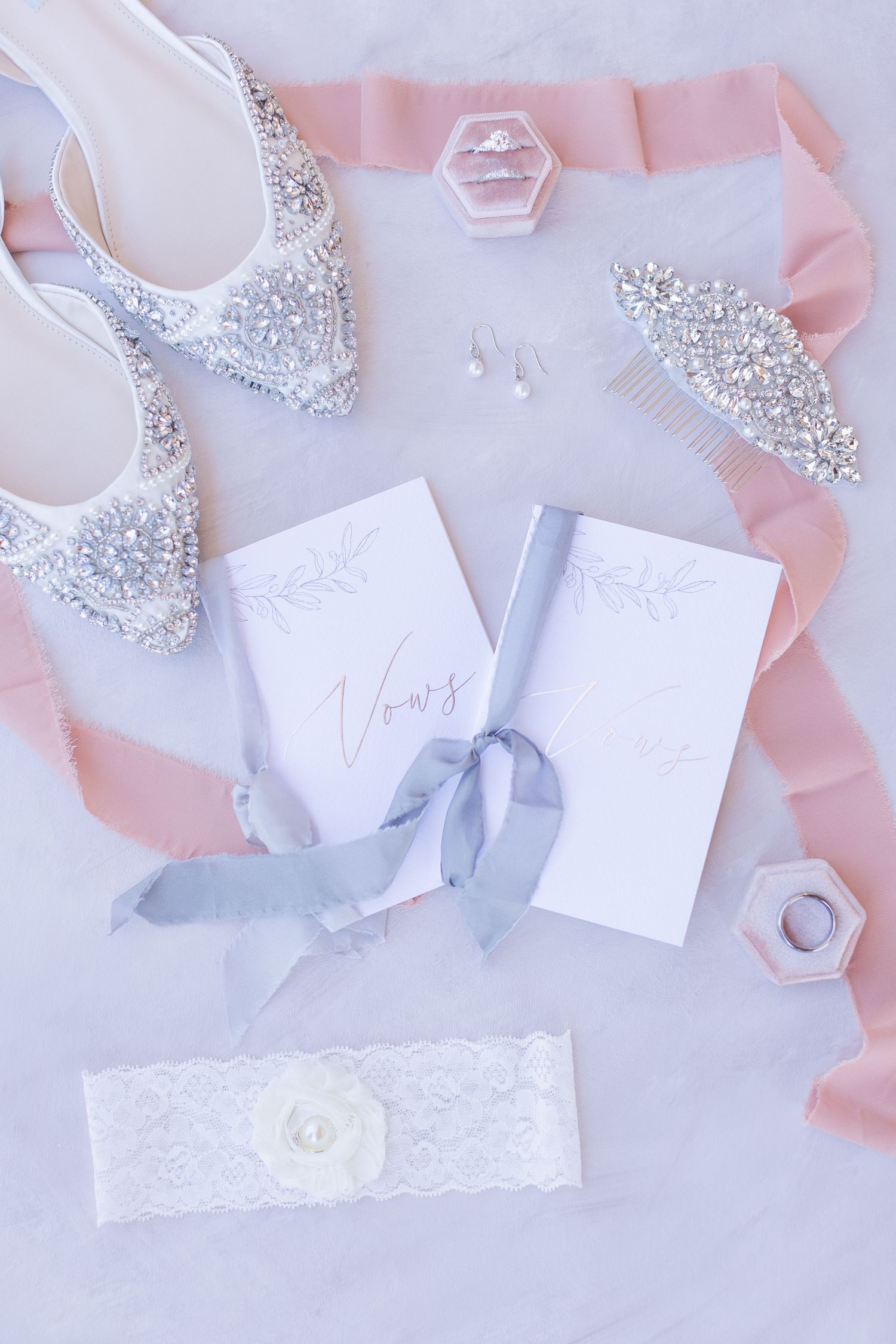 Betsy Johnson Wedding flats along with vow books and wedding rings.