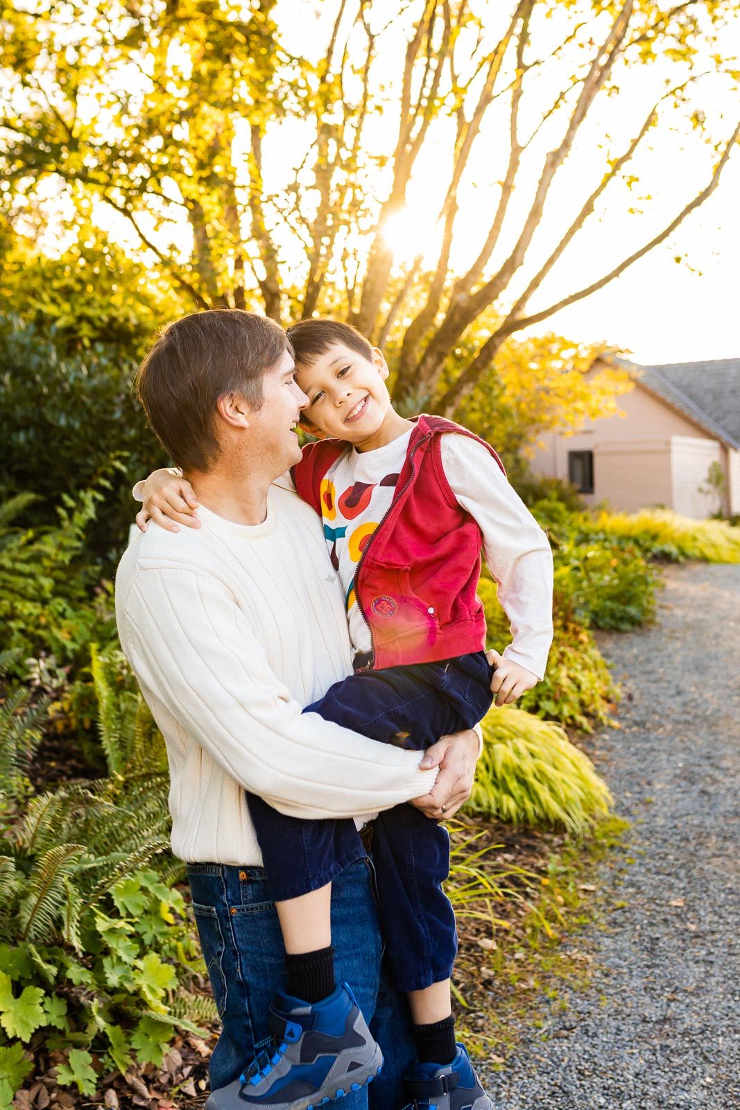 Father hugging son backlit at golden hour