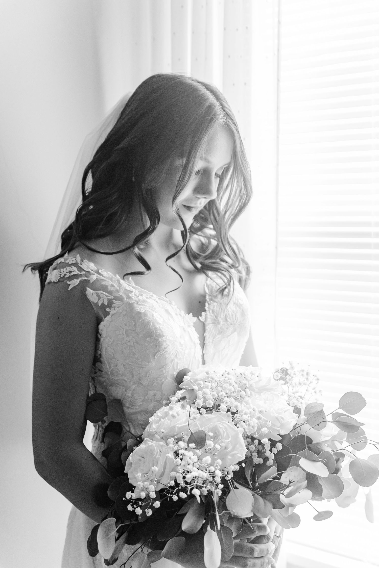 Black and white bridal portrait with delicate lace details and baby's breath bouquet.