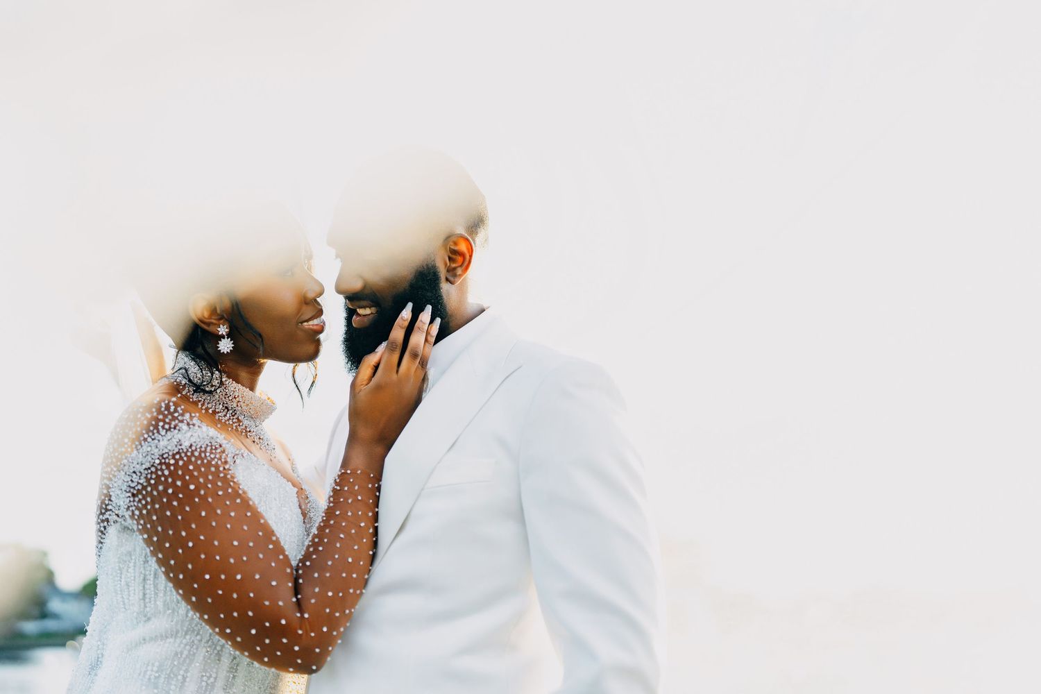 Minimalist wedding portrait against white background capturing intimate moment.