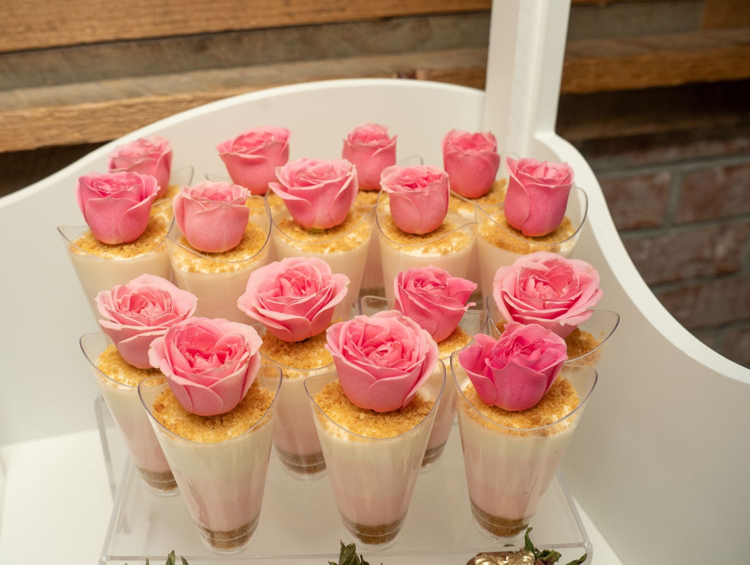 Pink rose desserts arranged on white serving trays for special celebration.