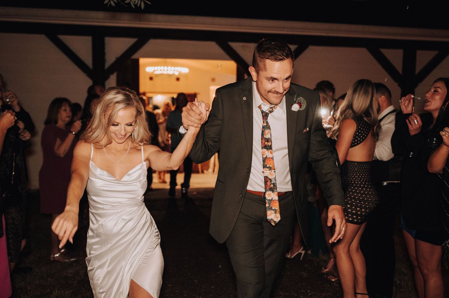 Couple dancing and celebrating at lively wedding reception party.