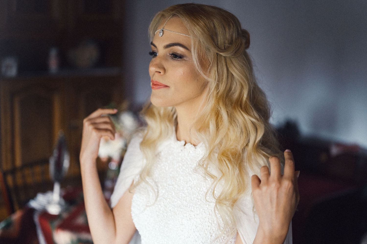 Close-up shot of elegant bridal makeup and wavy blonde hair.