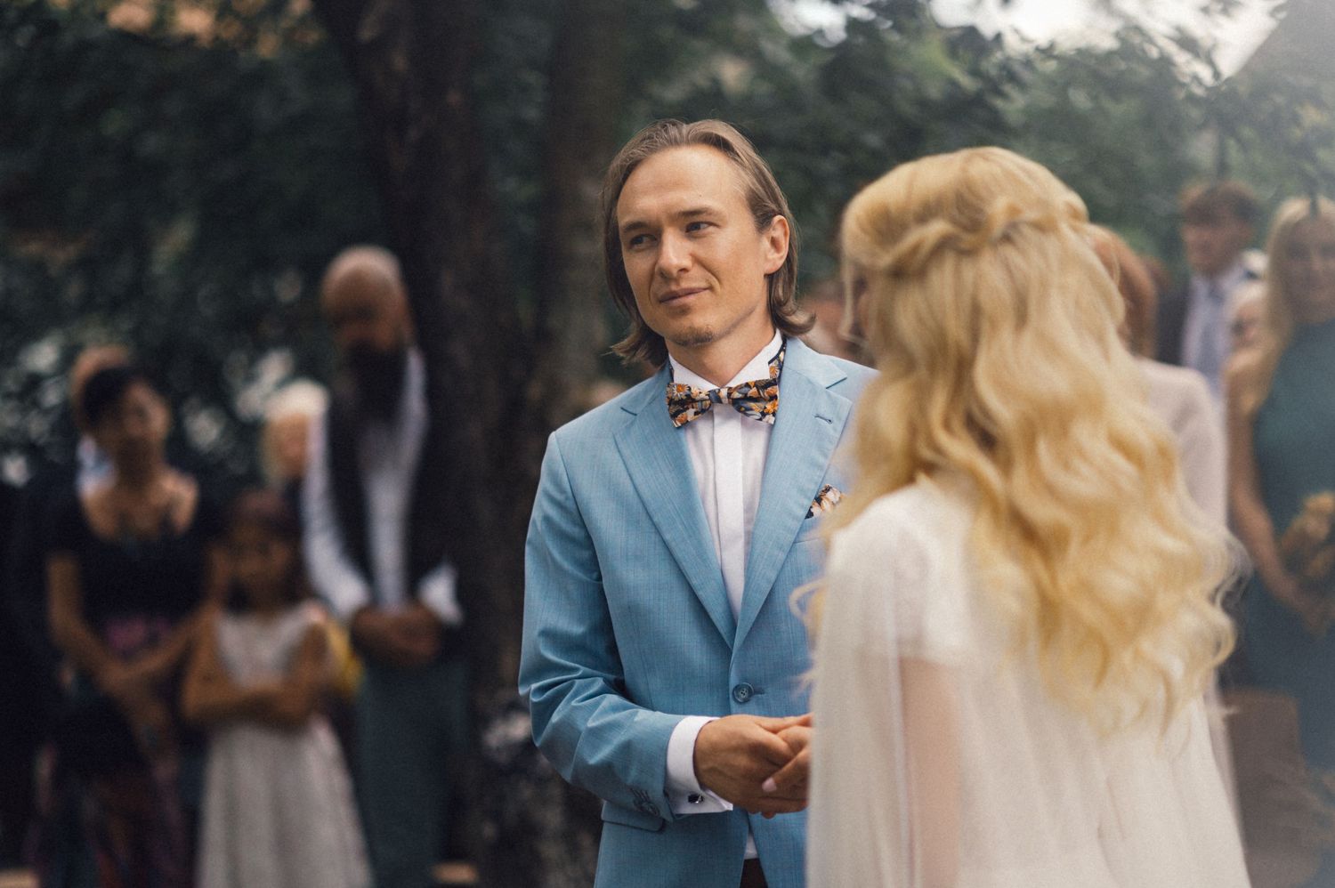A couple shares a moment during their garden wedding ceremony.