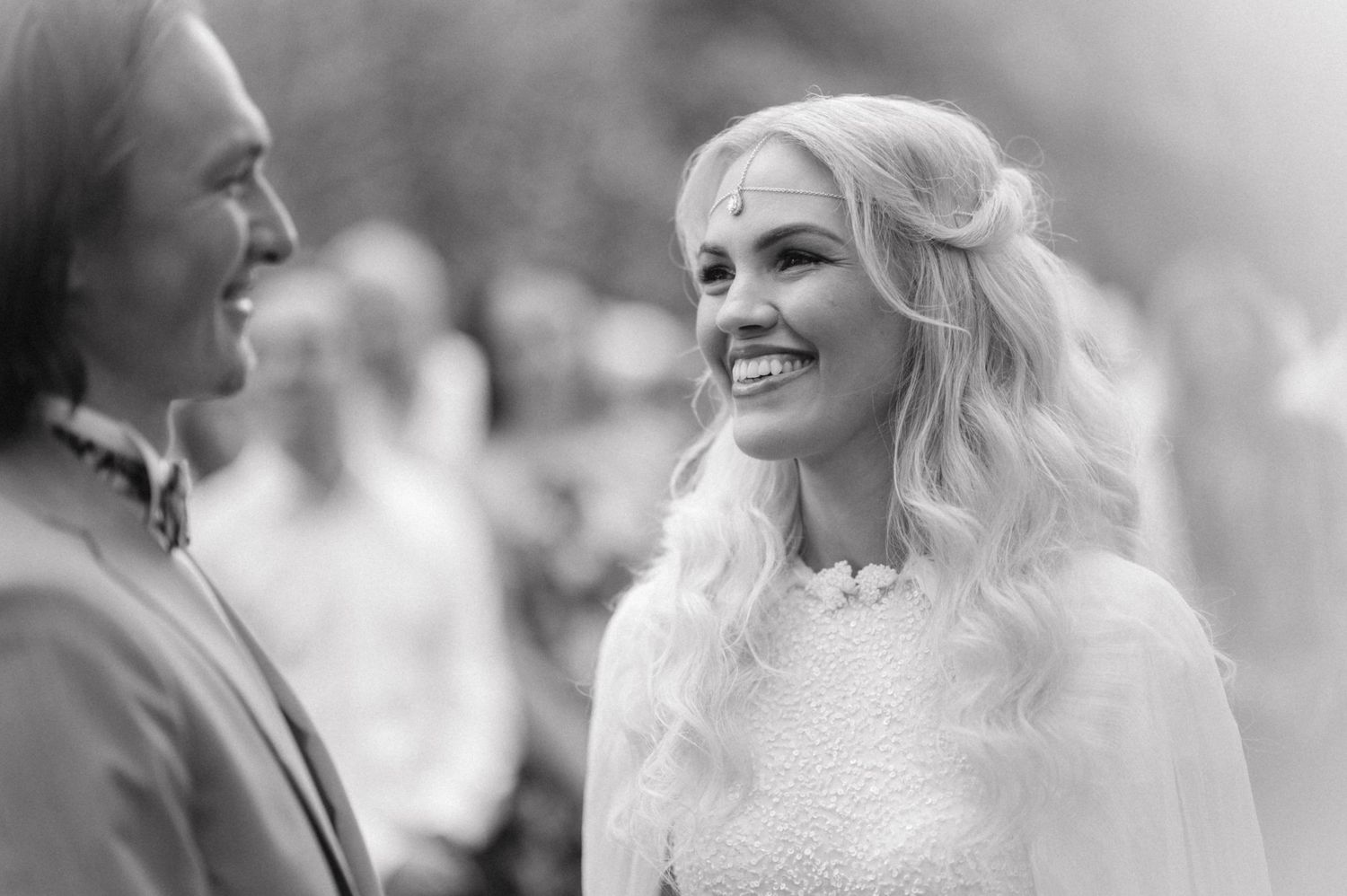 A black and white portrait of a couple during their wedding ceremony.