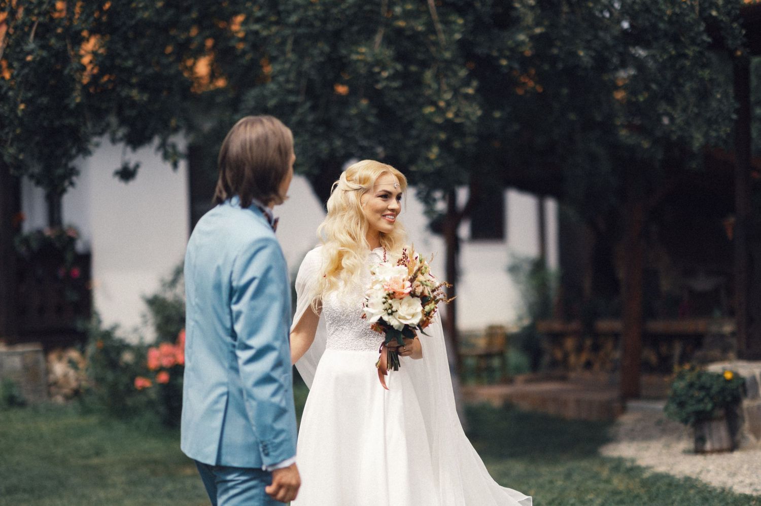 A beautiful outdoor wedding ceremony in a garden with elegant floral decorations.