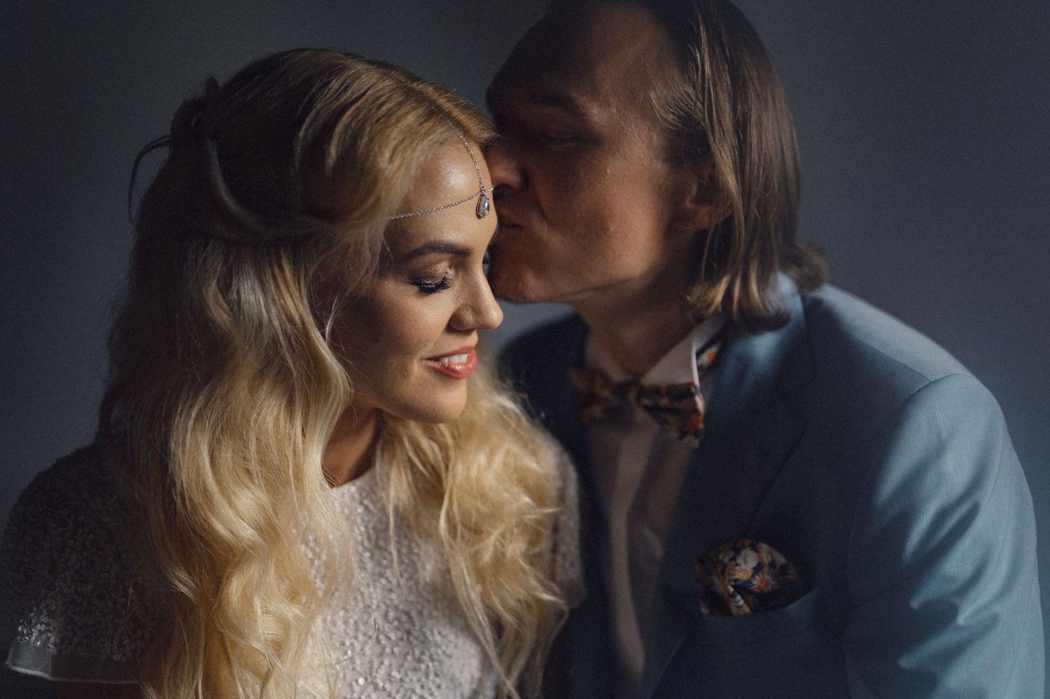 Intimate wedding portrait with soft lighting and elegant attire.