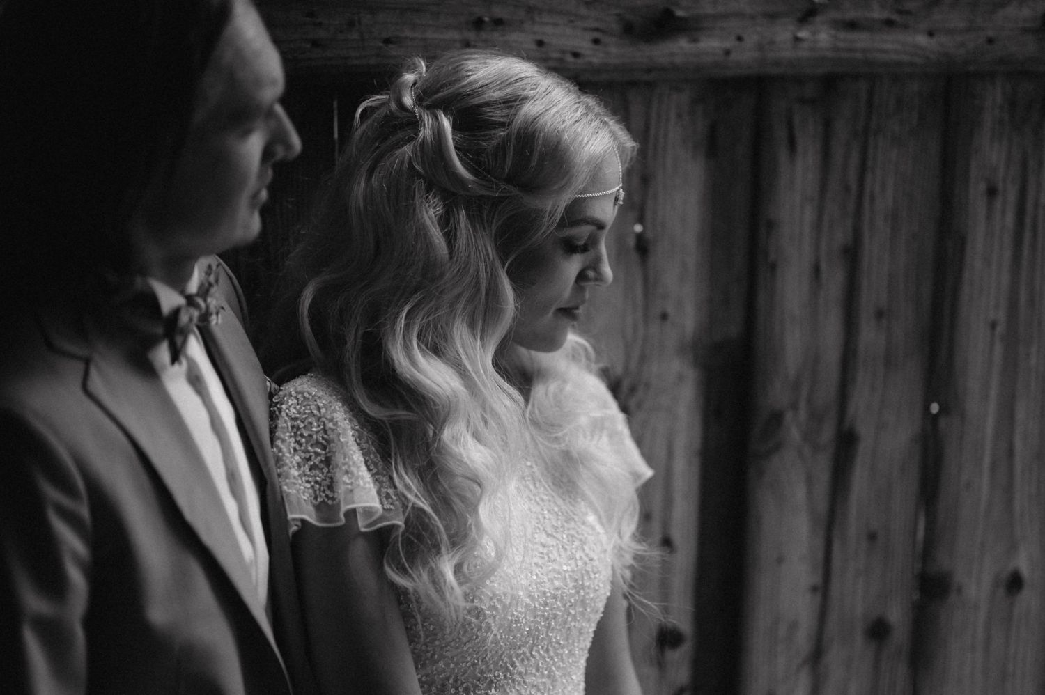 A black and white portrait capturing an intimate side profile of newlyweds.