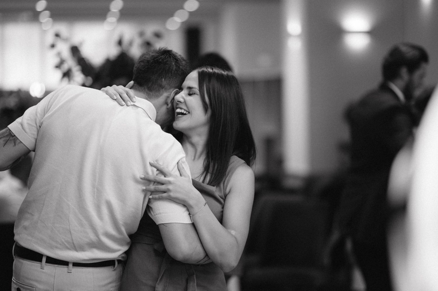 A black and white capture of a couple sharing an intimate dance moment.