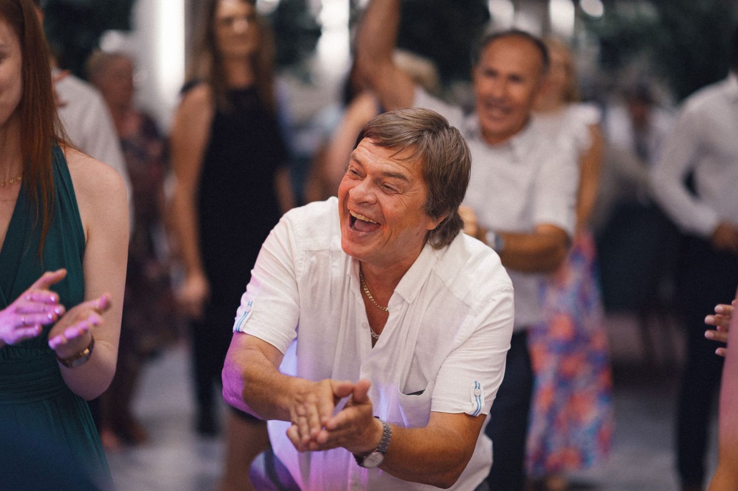 Guest enjoying themselves on the dance floor at a wedding celebration.